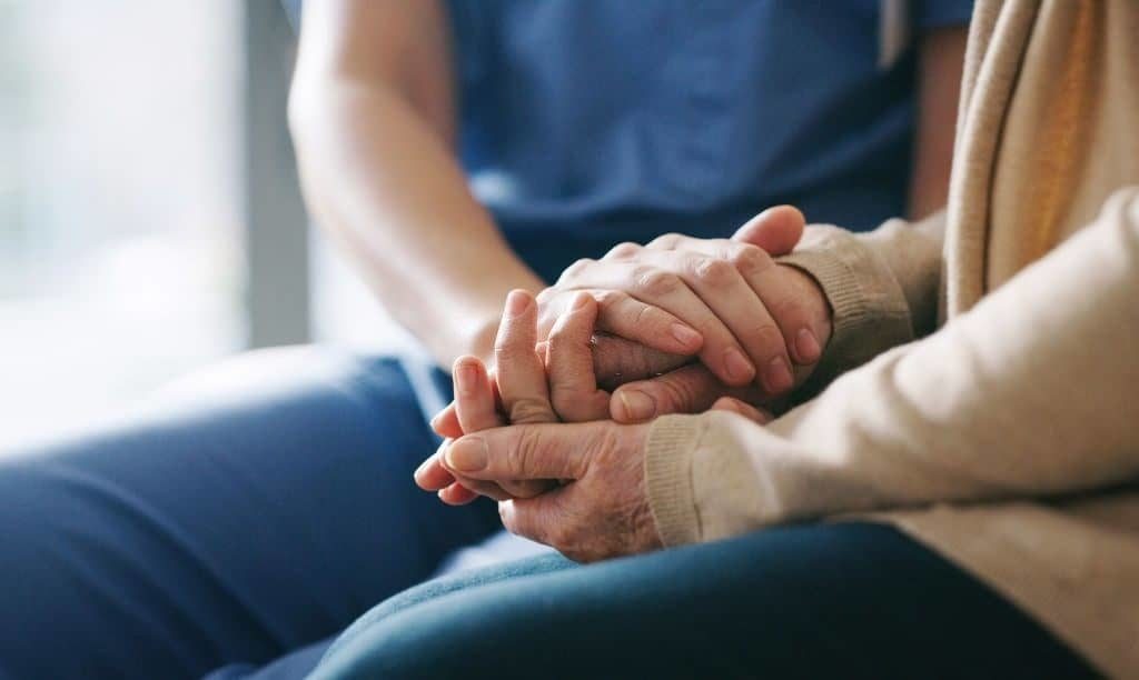 Nurse Holding Hands of a Patient